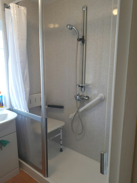 new easy access shower with shower seat and grab rails