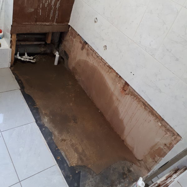 damp on walls and floors from leaking bath
