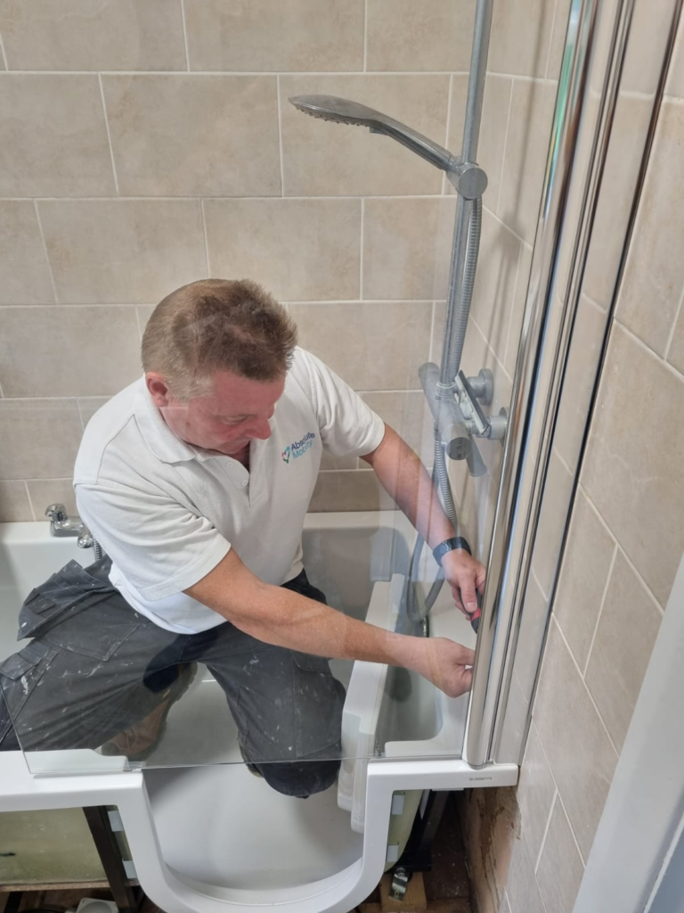 Absolute Mobility installer fitting an accessible bath - second fix