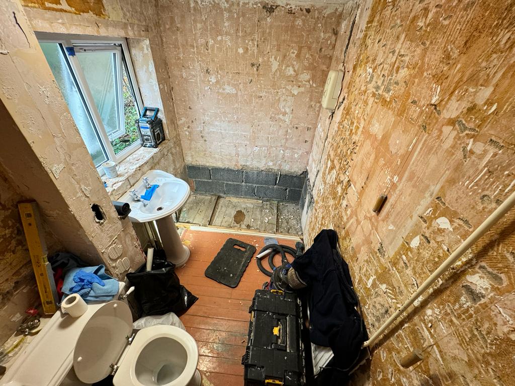 Bathroom adaptation to accessible shower room for person experiencing arthritis, first fix