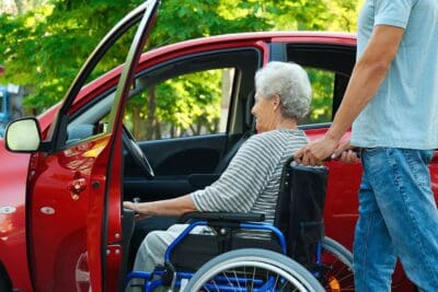 Bigstock Young Man Helping Disabled Sen 317517400