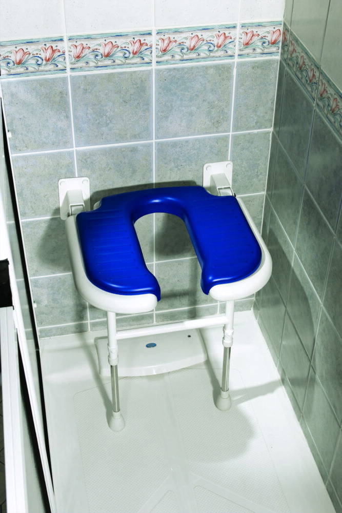 Wall-mounted horseshoe-shaped padded shower seat with blue cushioning and adjustable legs.