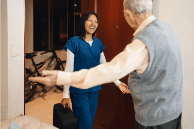 Carer Greeting Elderly Gentleman