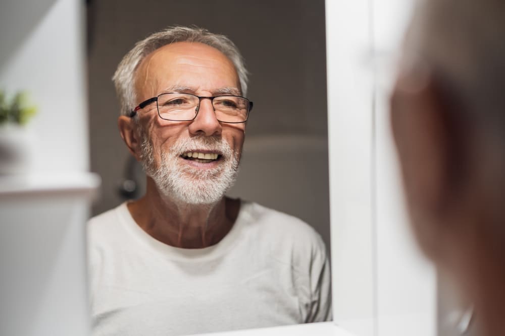 Elderly Man Looking In Mirror