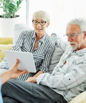 Man And Woman Looking At Tablet