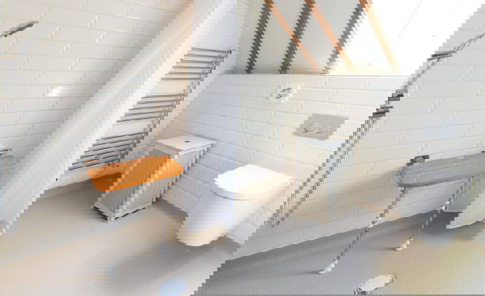 Wheelchair accessible bathroom, with low access floor, and a shower seat