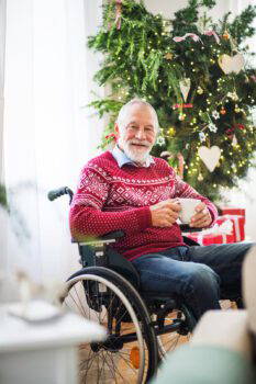 A Senior Man In Wheelchair With A Cup Of Tea Wearing A Knitted Jumper