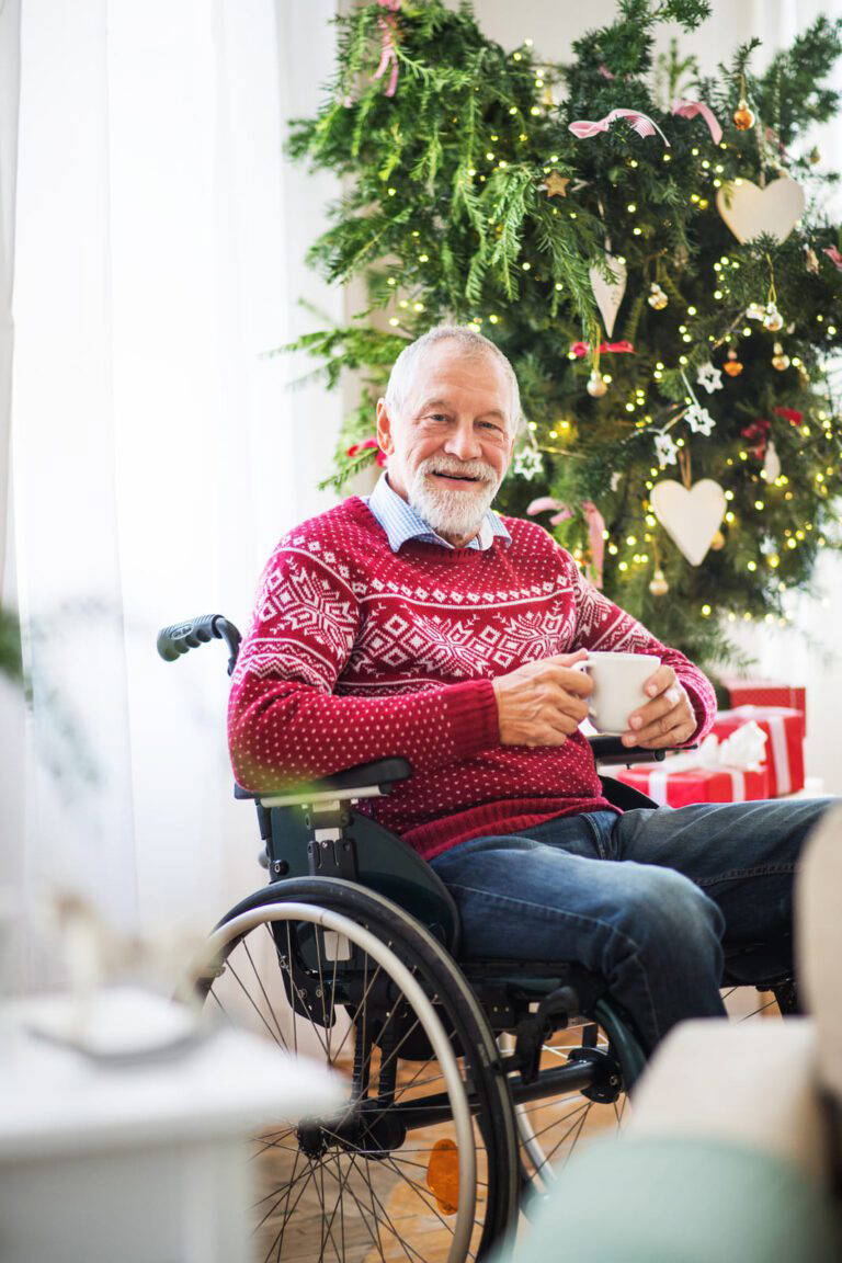 A Senior Man In Wheelchair With A Cup Of Tea Wearing A Knitted Jumper